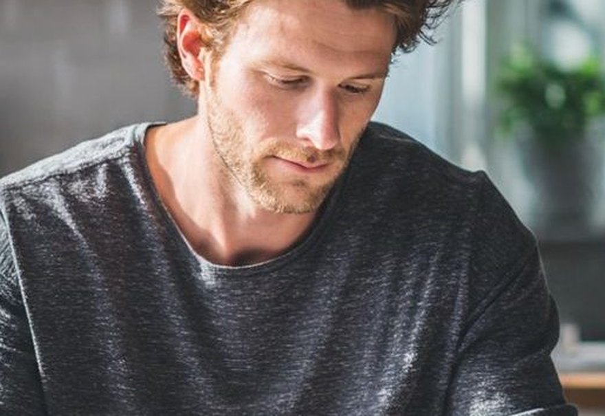 Man reviewing his paperwork — Lending Buddy eligibility